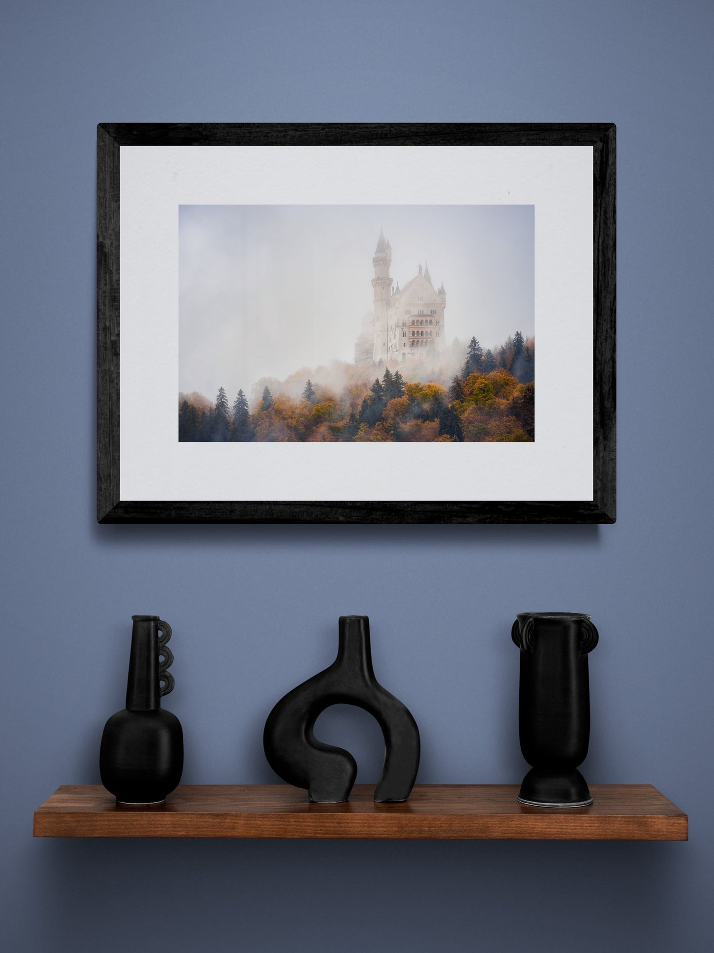 Image Title: Autumn under Neuschwanstein Photographer: Marcus Danz Location: Schwangau, Germany Image description: Shrouded in mist, Neuschwanstein Castle towers majestically above the autumnly colored woods. High quality Fine Art print up to 36 inch / around 90 centimeters on Hahnemühle paper available. Small variant over shelf.