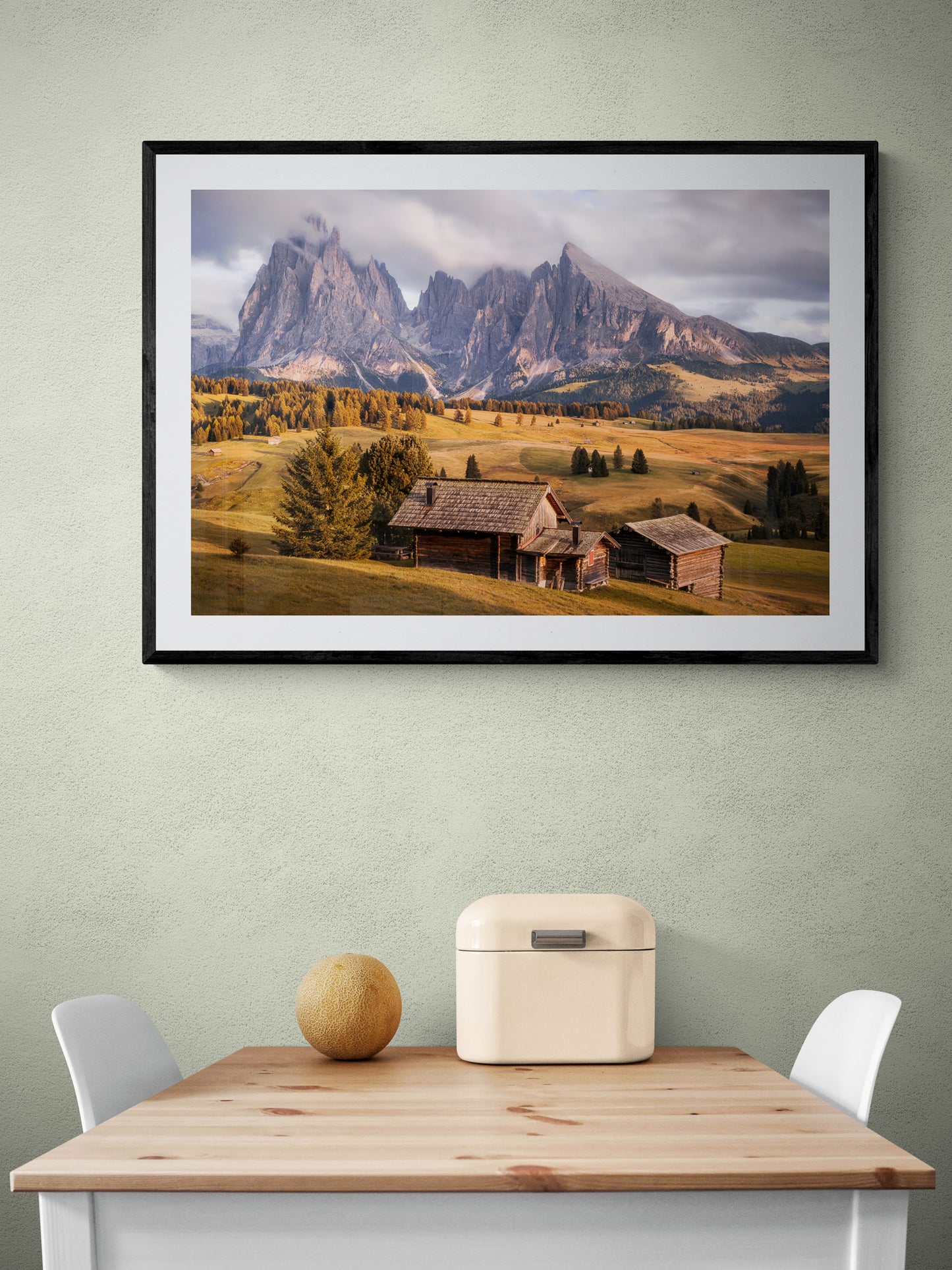 Image Title: A Tyrol Tidbit Photographer: Marcus Danz Location: Alpe di Siusi, Italy Image description: While increasingly dense clouds pass by the peaks of the mighty Sassolungo group, the pasture catches the warm light of the soon-to-set sun one more time. High quality Fine Art print up to 36 inch / around 90 centimeters on Hahnemühle paper available. Large variant over kitchen table.