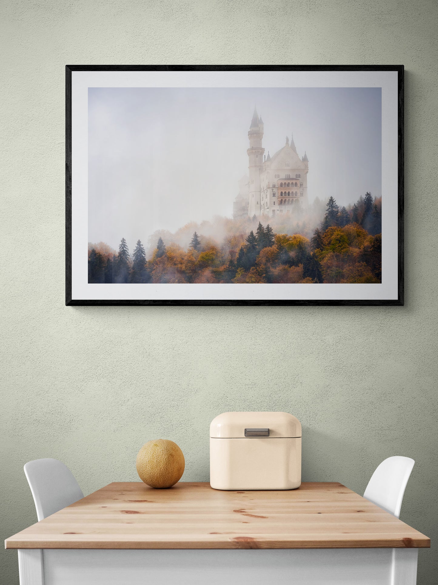 Image Title: Autumn under Neuschwanstein Photographer: Marcus Danz Location: Schwangau, Germany Image description: Shrouded in mist, Neuschwanstein Castle towers majestically above the autumnly colored woods. High quality Fine Art print up to 36 inch / around 90 centimeters on Hahnemühle paper available. Large variant over kitchen table.