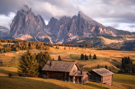 Image Title: A Tyrol Tidbit Photographer: Marcus Danz Location: Alpe di Siusi, Italy Image description: While increasingly dense clouds pass by the peaks of the mighty Sassolungo group, the pasture catches the warm light of the soon-to-set sun one more time. High quality Fine Art print up to 36 inch / around 90 centimeters on Hahnemühle paper available.