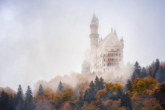 Image Title: Autumn under Neuschwanstein Photographer: Marcus Danz Location: Schwangau, Germany Image description: Shrouded in mist, Neuschwanstein Castle towers majestically above the autumnly colored woods. High quality Fine Art print up to 36 inch / around 90 centimeters on Hahnemühle paper available.