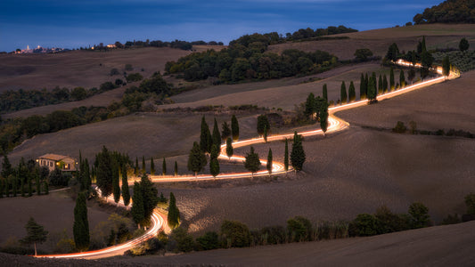 Image Title: Glowing Cypress Road Photographer: Marcus Danz Location: Monticchiello, Italy Image description: Car lights trace the winding course of one of the most beautiful cypress roads in Tuscany, Italy. High quality Fine Art print up to 36 inch / around 90 centimeters on Hahnemühle paper available.