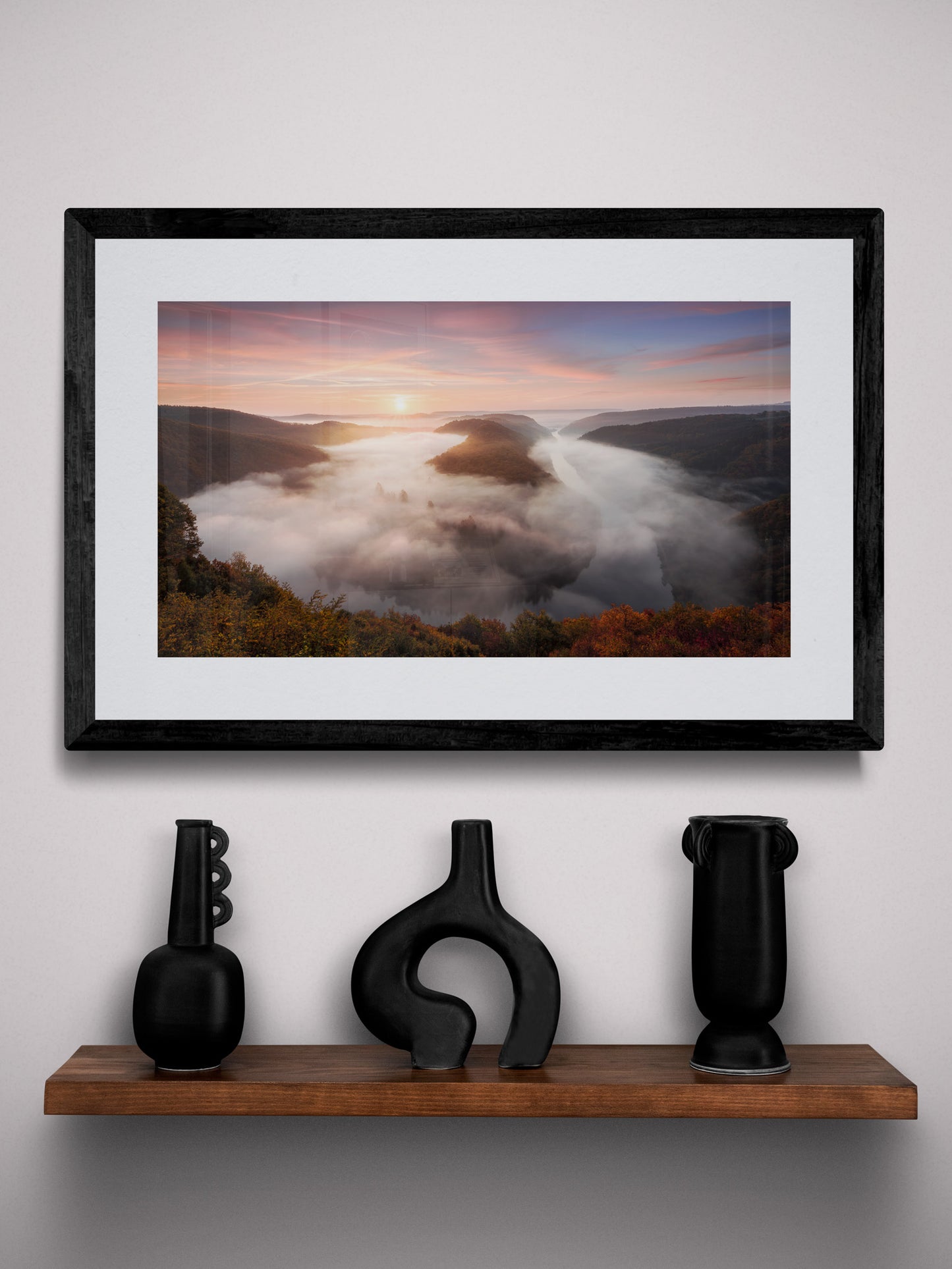 Image Title: The foggy Loop Photographer: Marcus Danz Location: Mettlach, Germany Image description: Mysterious morning fog drifts silently through Mettlach’s Saar loop, partly lit by the warm light of the rising sun. High quality Fine Art print up to 36 inch / around 90 centimeters on Hahnemühle paper available. Small variant over shelf.
