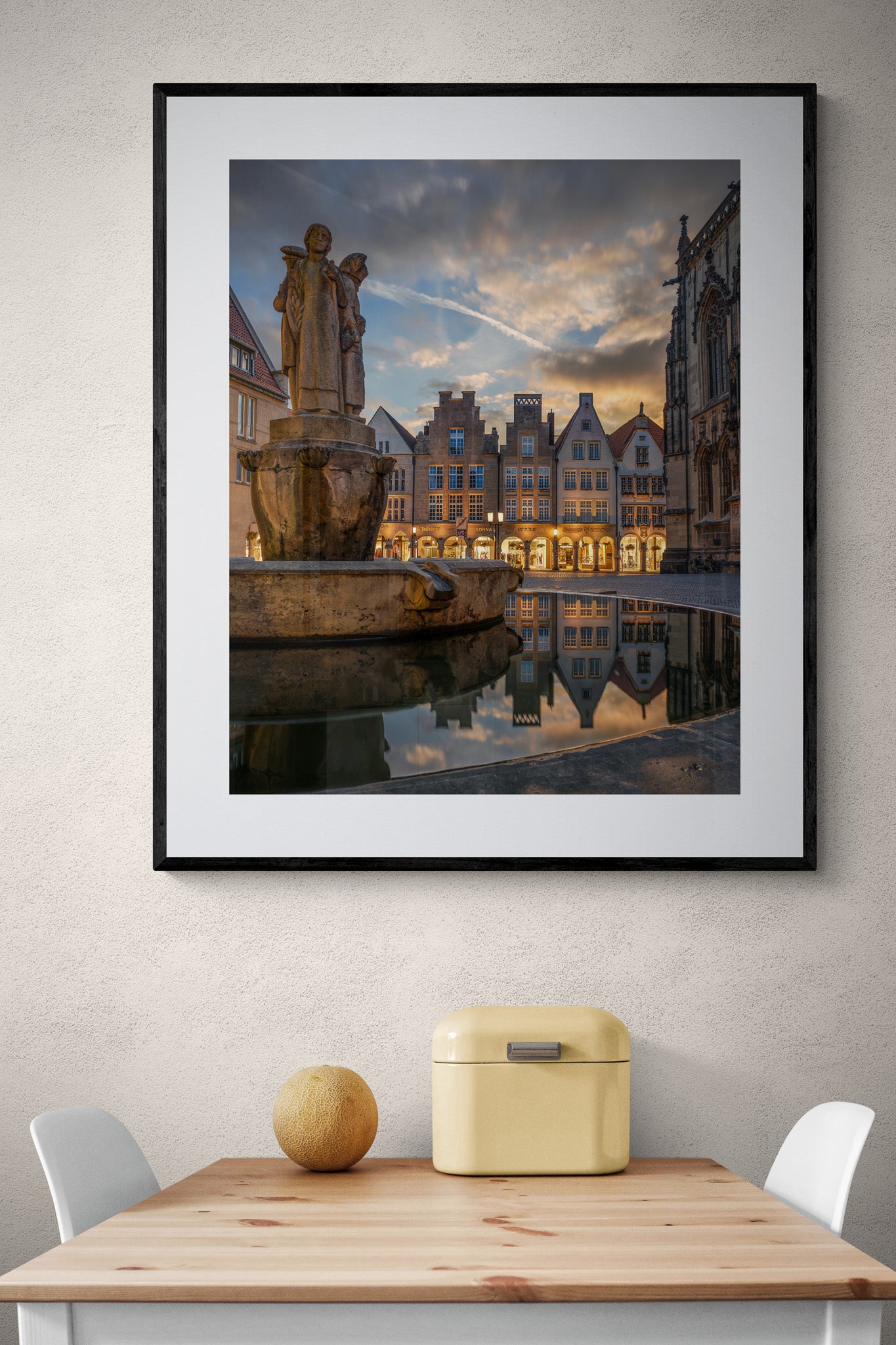 Image Title: Well, it's Münster!  Photographer: Marcus Danz Location: Münster, Germany Image description: Münster's ”Prinzipalmarkt“ is reflected in the water of a fountain during sunset. High quality Fine Art print up to 36 inch / around 90 centimeters on Hahnemühle paper available. Large variant over kitchen table.