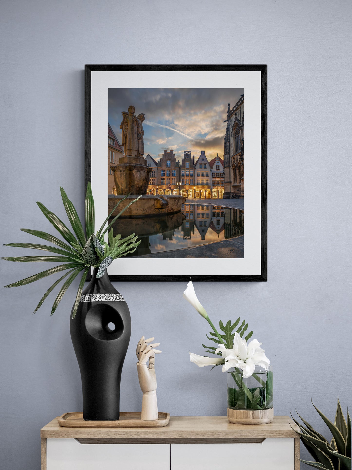 Image Title: Well, it's Münster!  Photographer: Marcus Danz Location: Münster, Germany Image description: Münster's ”Prinzipalmarkt“ is reflected in the water of a fountain during sunset. High quality Fine Art print up to 36 inch / around 90 centimeters on Hahnemühle paper available. Medium variant over sideboard.