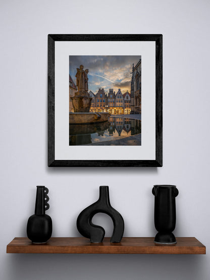 Image Title: Well, it's Münster!  Photographer: Marcus Danz Location: Münster, Germany Image description: Münster's ”Prinzipalmarkt“ is reflected in the water of a fountain during sunset. High quality Fine Art print up to 36 inch / around 90 centimeters on Hahnemühle paper available. Small variant over shelf.